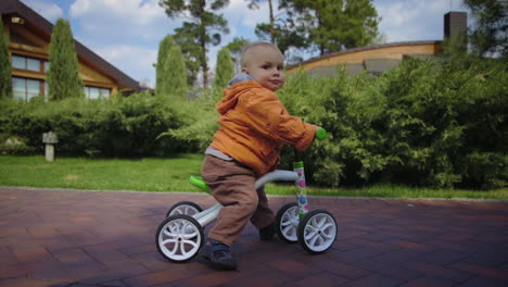 little kid riding on cycle outdoor