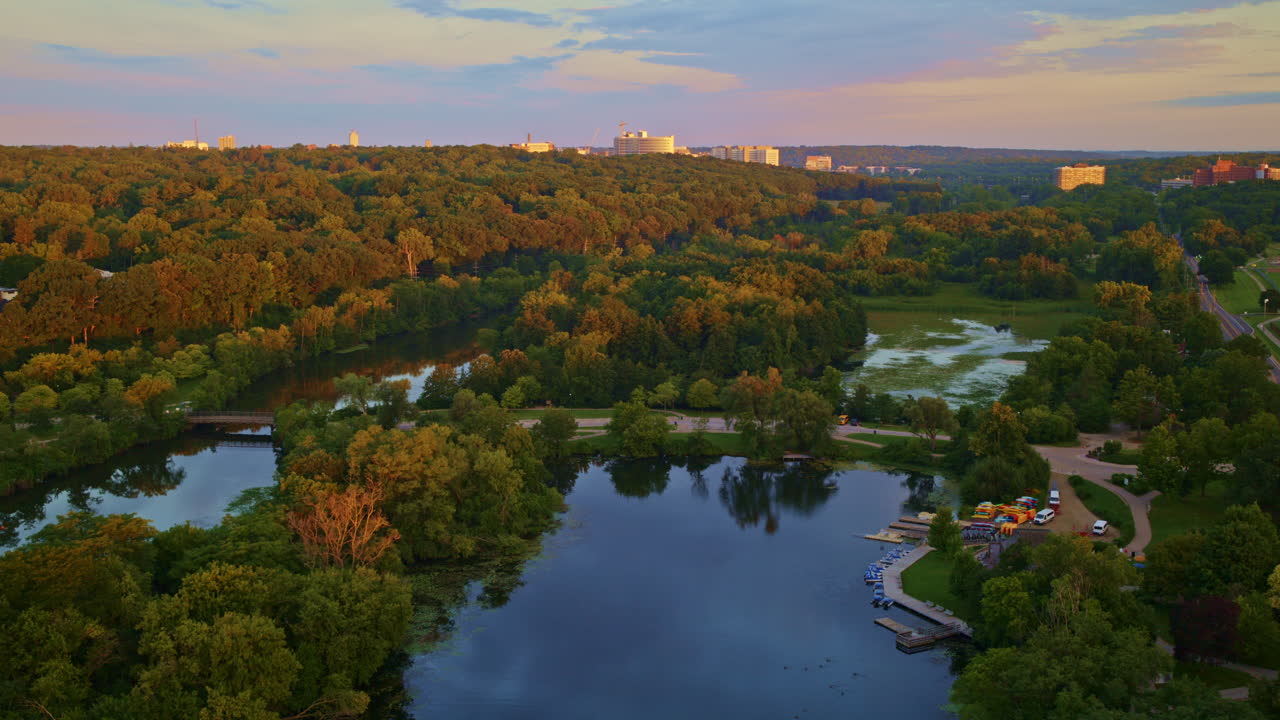 Slow-moving drone view of the Huron River in Ann Arbor, Michigan, captured in summer.