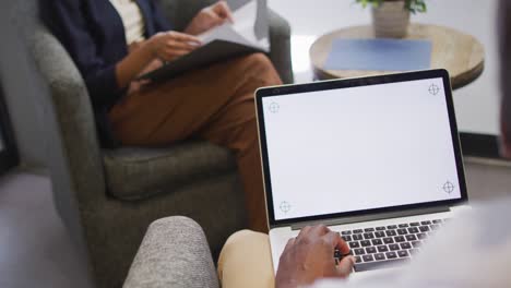 two diverse business people working together, using laptop with copy space in modern office