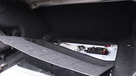 panels and covers removed inside a vehicle or cars boot space for work