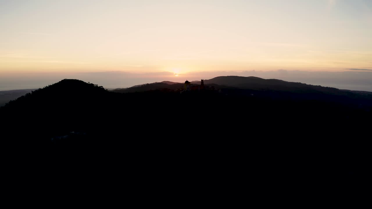 Drone shot of Sunset with palace on top of a mountain
