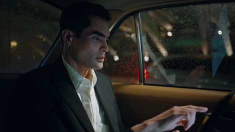 focused director working computer in vehicle closeup. business man typing tablet