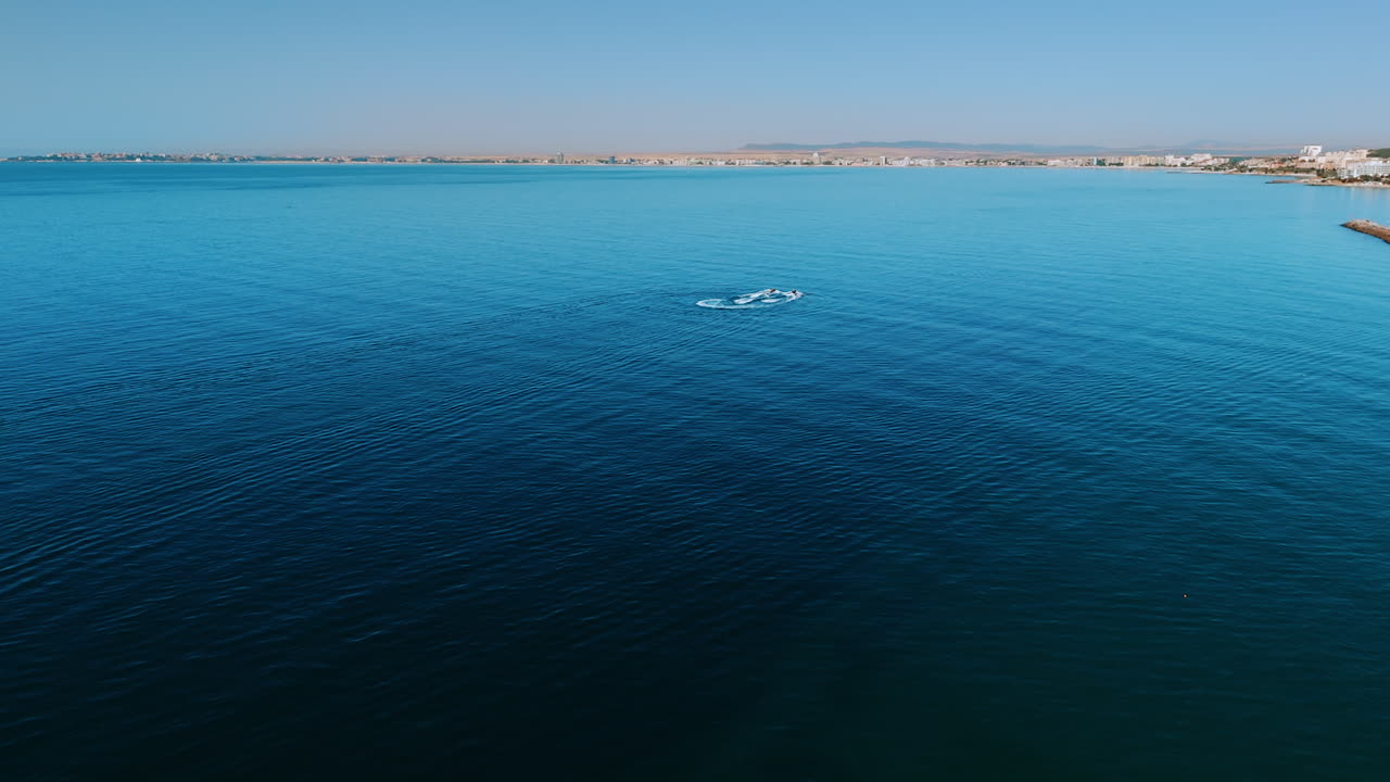 Aerial view of the Black Sea waters near Sveti Vlas. Minimalistic aerial shot of the calm Black Sea waters near Sveti Vlas, Bulgaria, with swimmers in the distance