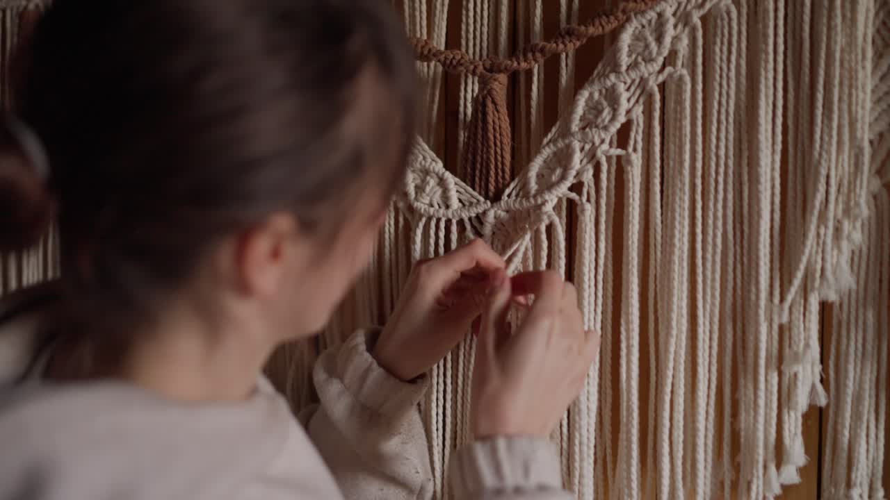 Woman making macrame wall art