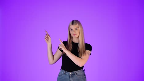 young blonde woman pointing up with hands and fingers, presentation gesture, studio shot