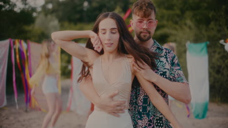 young man dancing bachata with brunette girlfriend