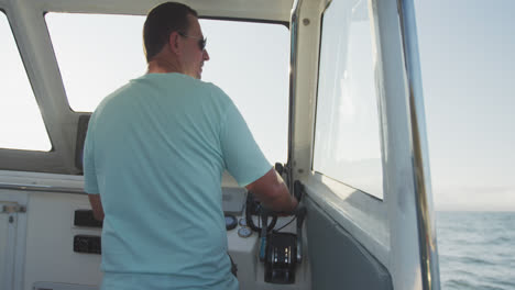 rear view of a caucasian man driving a boat