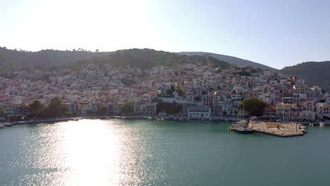 Aerial:-Orbit-shot-of-Skopelos-Island-Chora-during-sunset