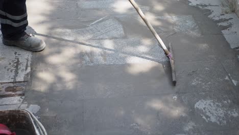 worker repairing a stone pavement