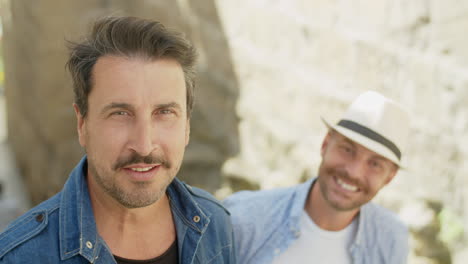 portrait of handsome gay dancing on stairs with boyfriend