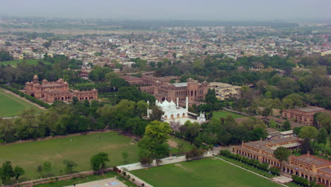 beautiful castle or emperor palace aerial view with green trees and forest, a white mosque centre of the city, houses at the back of the castle, a telecom tower in the city