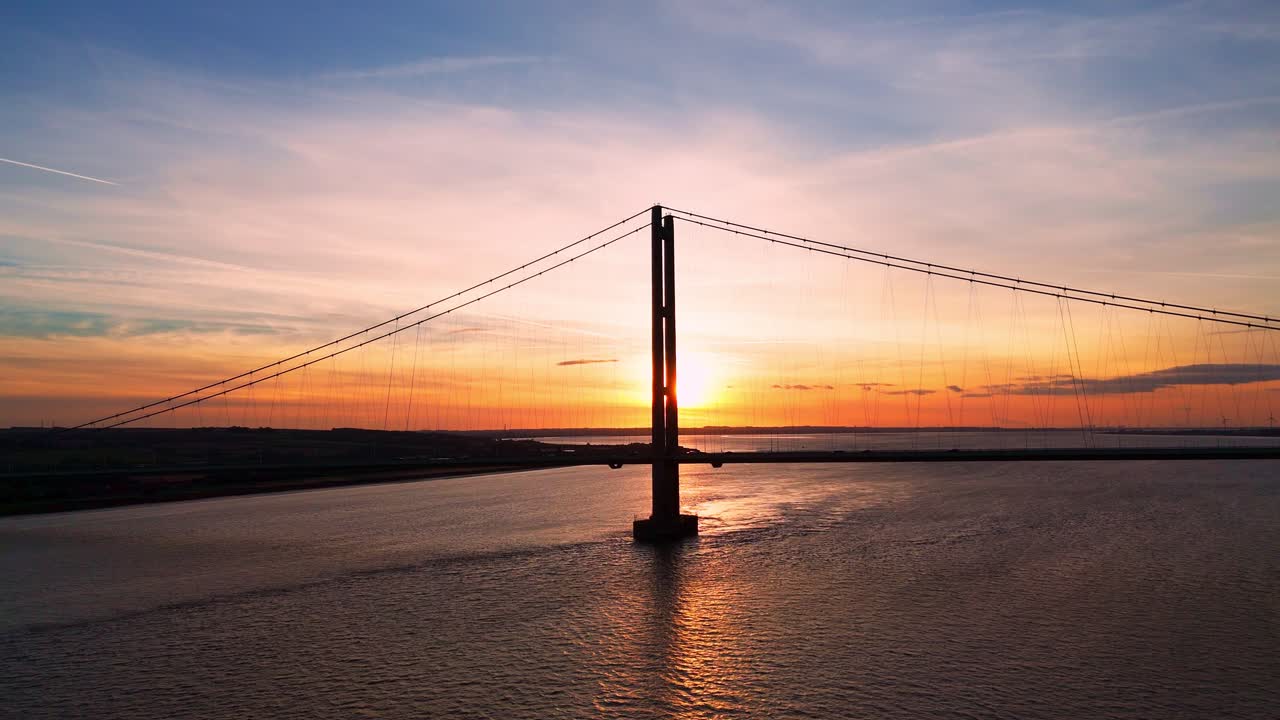 Sunset's canvas: Aerial view of Humber Bridge with cars in transit