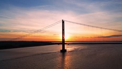 sunset's canvas: aerial view of humber bridge with cars in transit