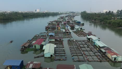 Floating-fish-farming-community-in-Bien-Hoa-on-the-Dong-Nai-river,-Vietnam-on-a-sunny-day