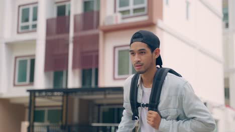 young man walking with backpack