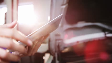 hands of mechanic using digital tablet