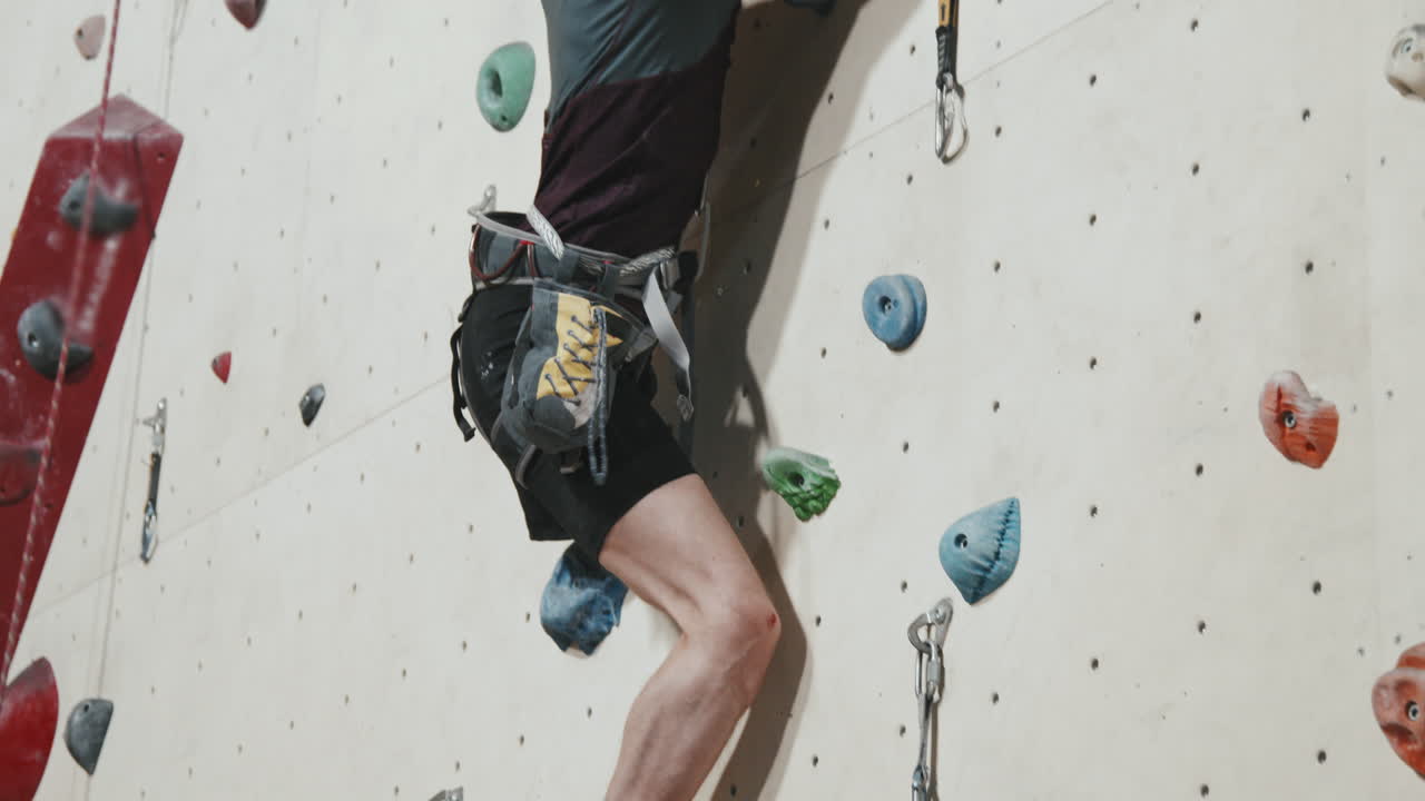 Male Athlete With Amputated Leg Climbing Wall Indoors