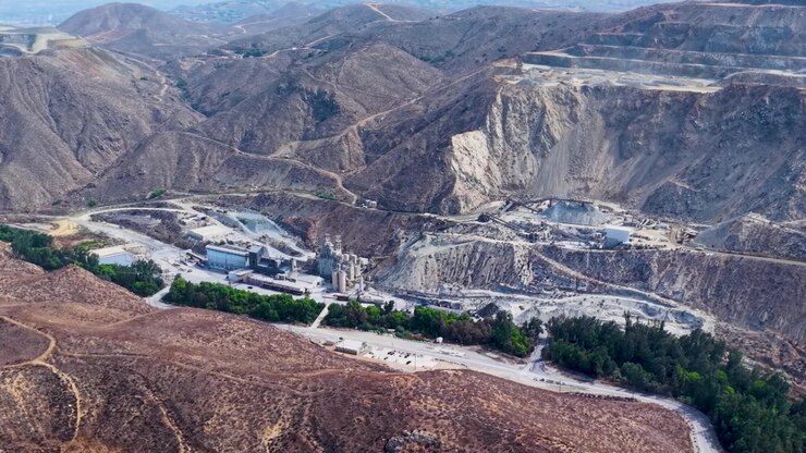 Aerial View of a Sand Quarry in corona California reveals the Massive Digging that goes on in these mountains. Noise Pollution and dust fill the air of nearby community.