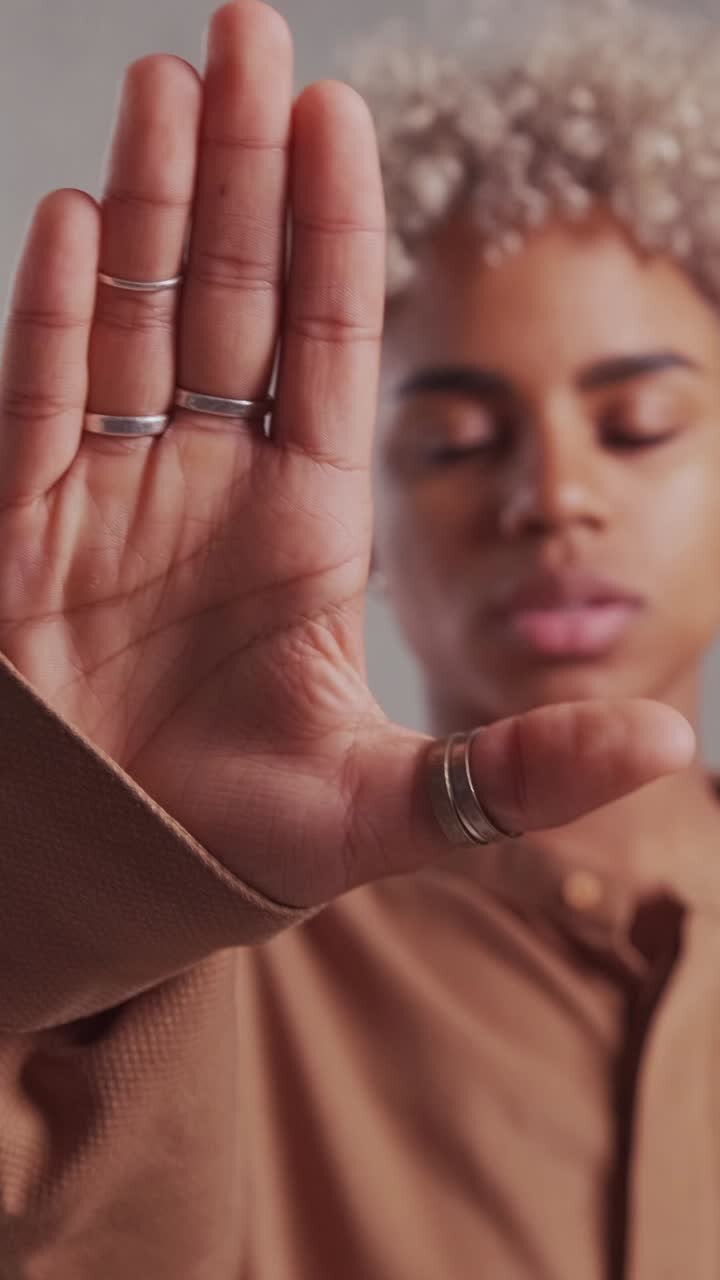 African american woman showing stop sign calling to cease violations of rights