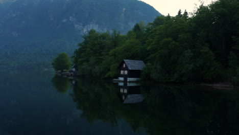 lakeshore cottages with reflections on lake bohinj in julian alps, triglav national park, slovenia