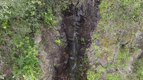 Descending-aerial-of-Cascata-do-Chilrao,-Chilrao-waterfall-in-Portugal