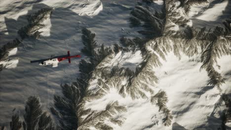 helicopter above mountains in snow