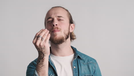 Caucasian-young-man-gesturing-on-camera.