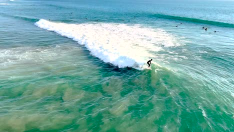 Surfers-trying-to-catch-a-wave-in-Huntington-Beach