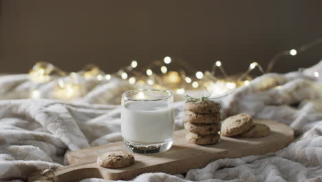 Video-of-christma-cookies,-glass-of-miljk-and-copy-space-on-white-background