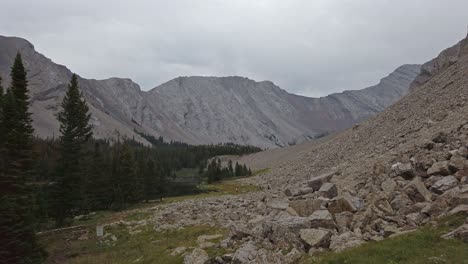 hikers in distance inside mountain valley approached rockies kananaskis alberta canada