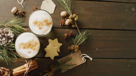 Video-of-cups-of-hot-chocolate-with-cinnamon-over-wooden-background