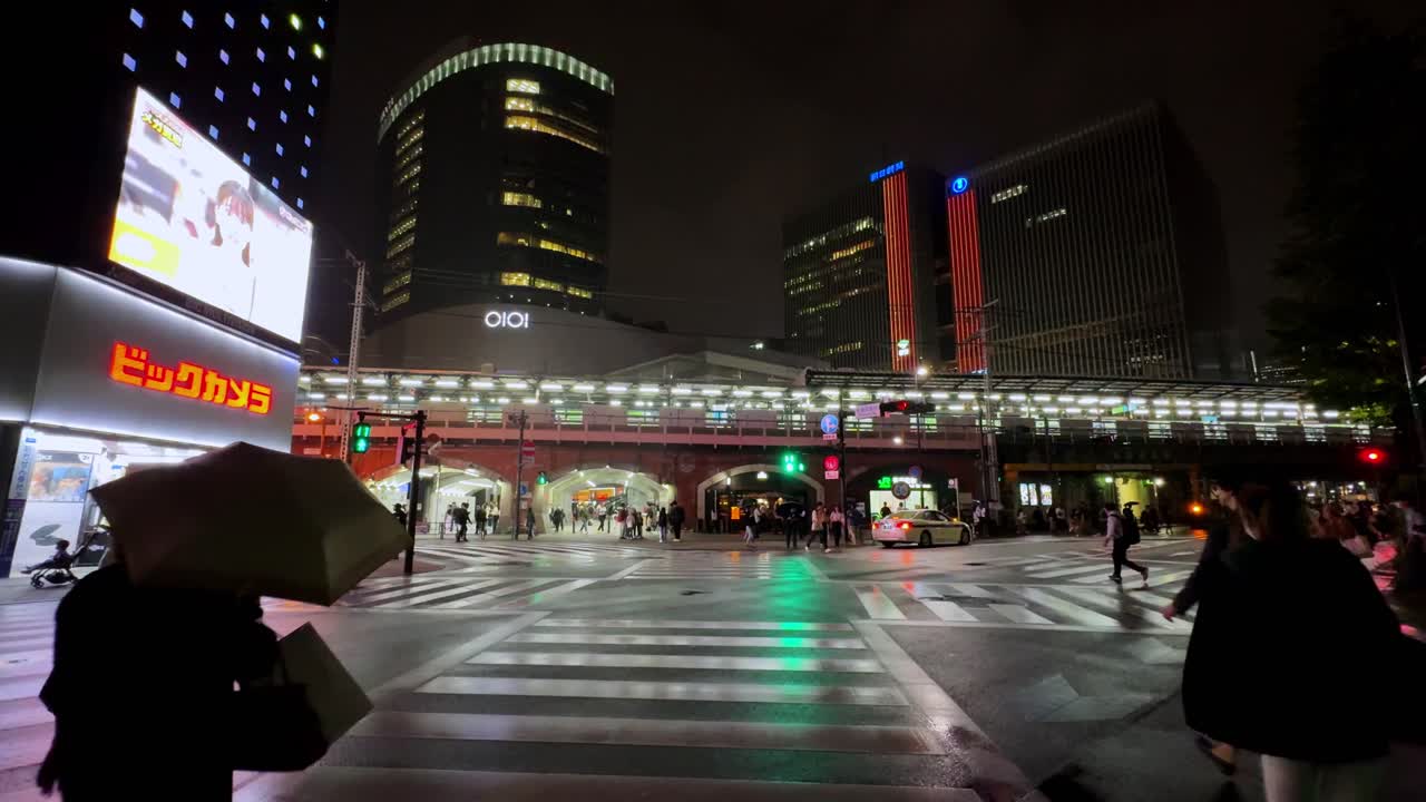 Rainy Night in Tokyo: A Cityscape of Lights and People