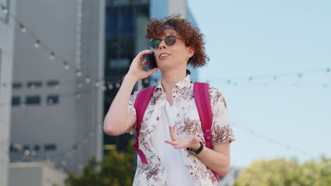 happy young man tourist having remote conversation communicate speaking by smartphone with friends