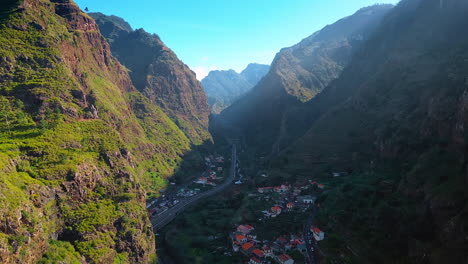 view on the town located between the high mountains. amazing scenery of the madeira islands, portugal from drone.