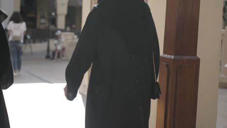 arab, middle eastern, muslim women walking at a dubai shopping mall in the middle east, unite arab emirates city of dubai near the burj khalifa