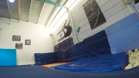 a-slow-motion-still-shot-of-a-guy-doing-flips-from-the-trampoline-landing-and-winning-having-fun-and-working-out-in-60fps