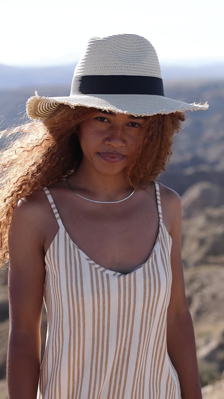 Woman in Straw Hat with Curly Hair Outdoors