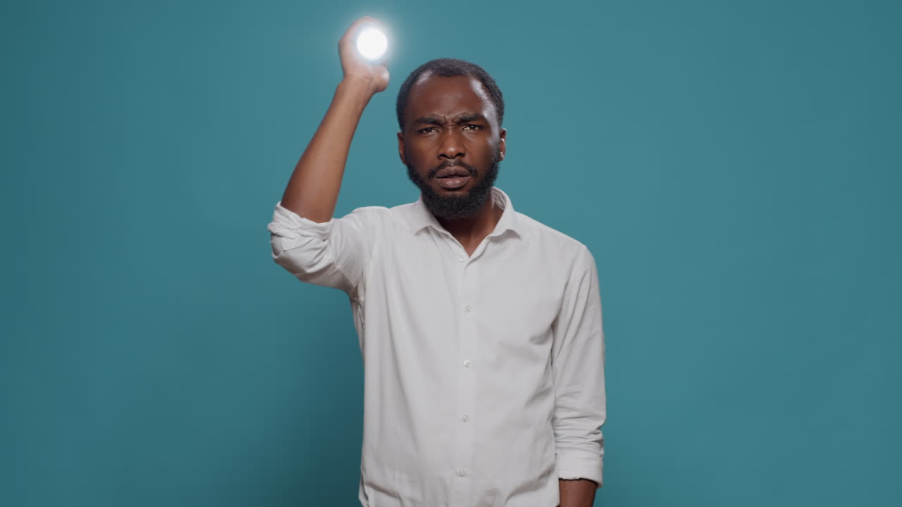 Man holding flashlight indoor