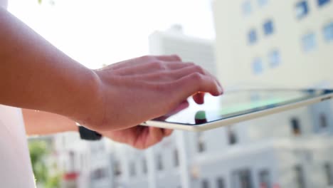 Close-up-of-hands-taping-on-a-tablet-computer