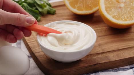 dipping carrot in mayo