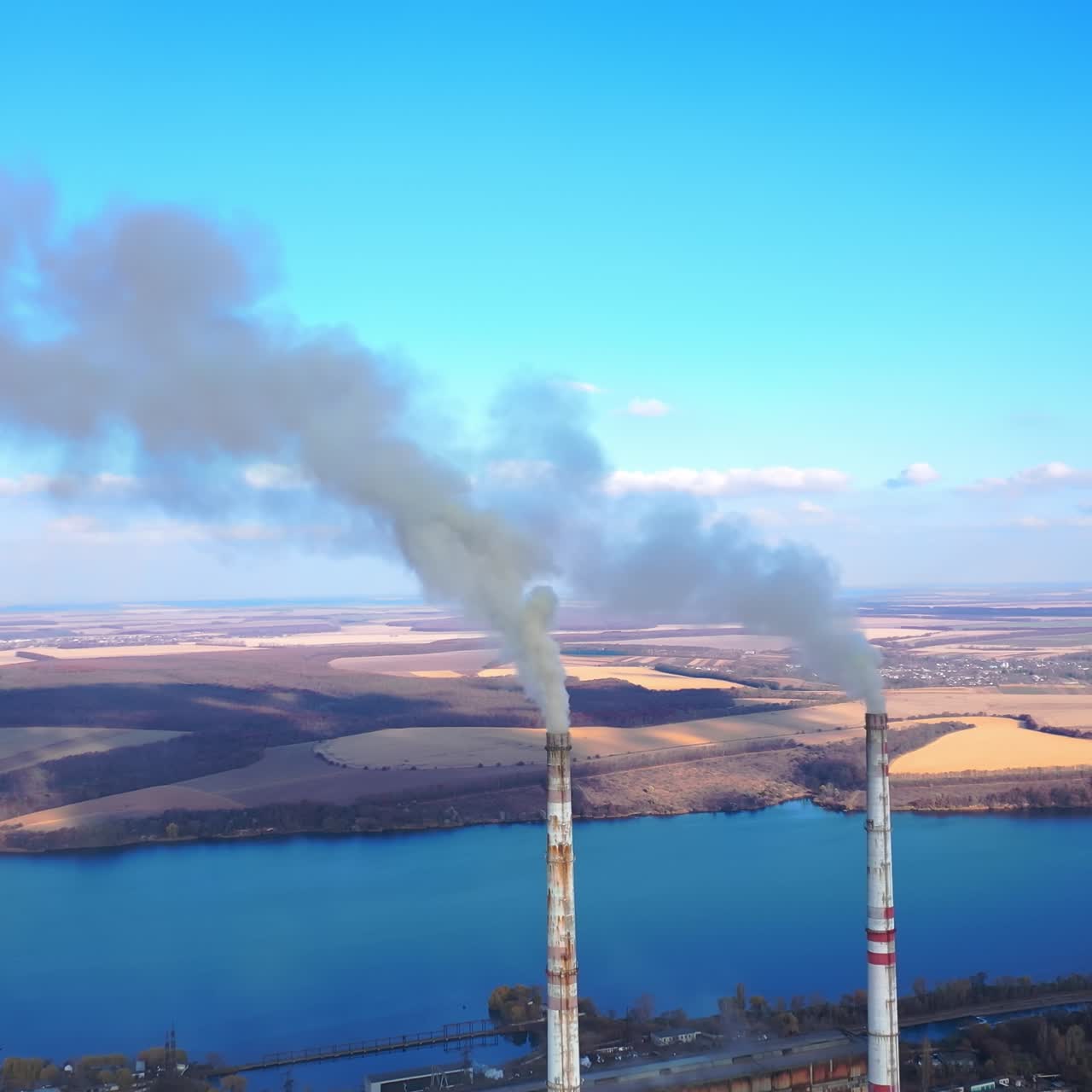 Industry energy producing air pollution. Aerial view of smoking factory tubes. Full length view
