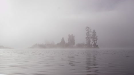 foggy dramatic scene looking across swan lake in montana