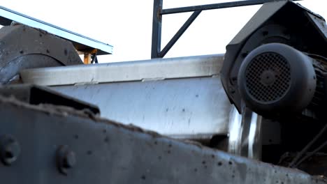 Working-car-shredder-machine,-close-up-of-sorting-drum-and-engines