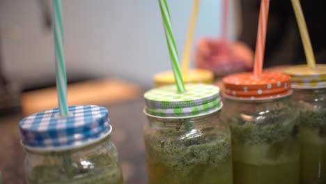 young latin girl prepare cocktail mocktail or smoothie at her kitchen