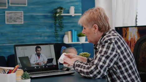 old patient talking with therapist by videoconference