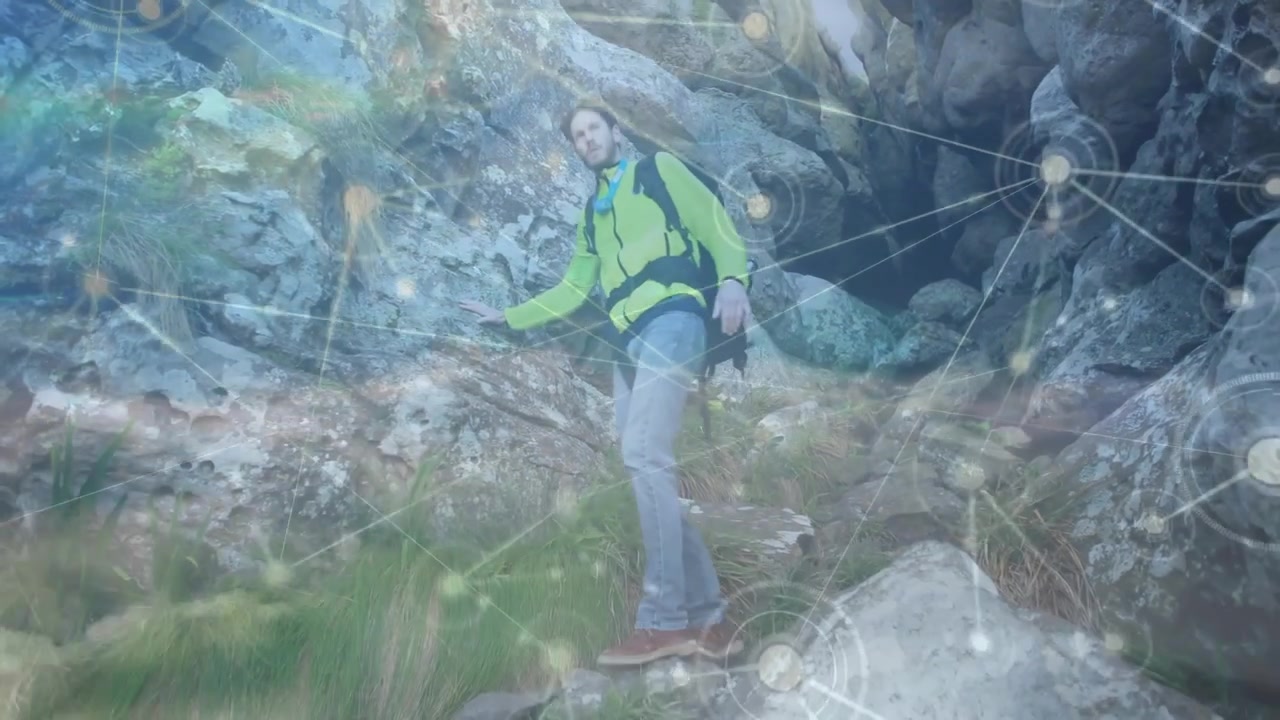 hiker emerging from crevice and descending slope safely as tech graphics highlighting connectivity
