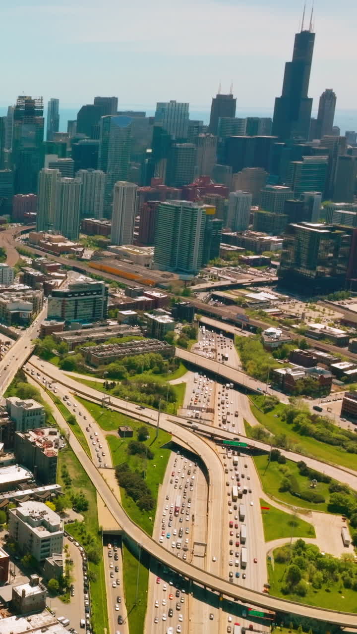 Sunny cityscape of wonderful Chicago. Busy road loops and diverse architecture at the backdrop of skyscrapers. Vertical video