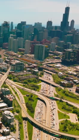 sunny cityscape of wonderful chicago. busy road loops and diverse architecture at the backdrop of skyscrapers. vertical video