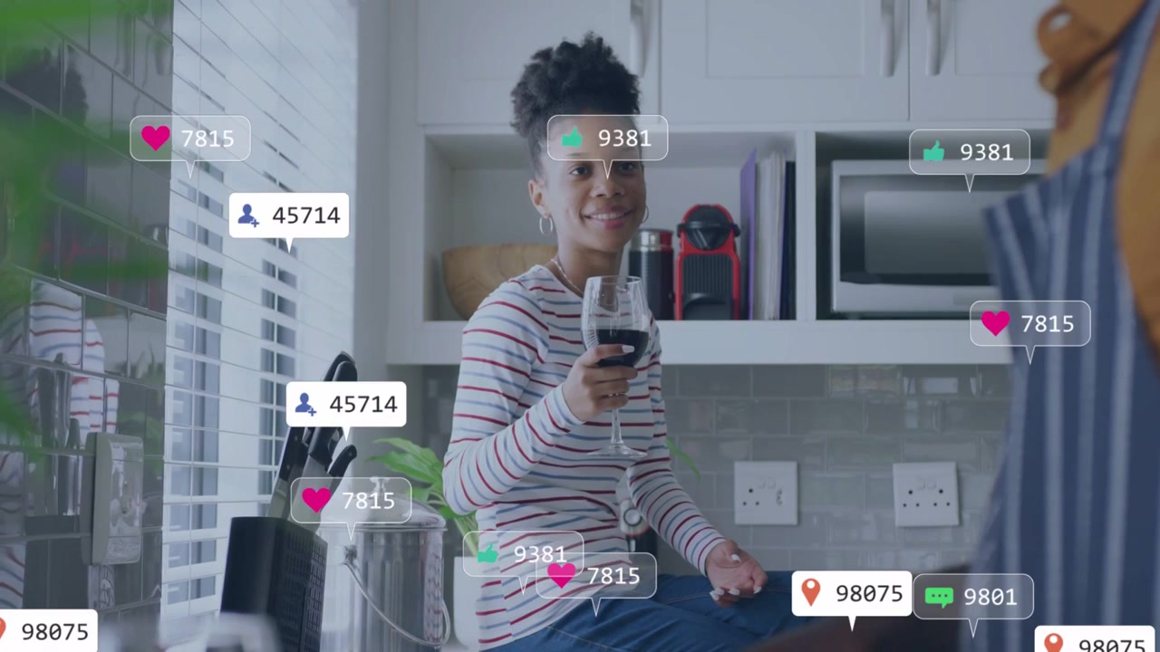 Woman holding wine on counter in kitchen man cooking, alerts popping left, floating, showing social
