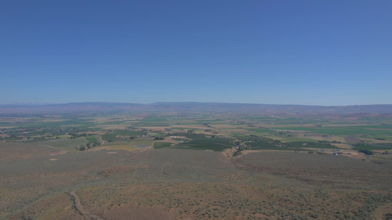 Aerial View of Vast Farmland and Mountain Landscape